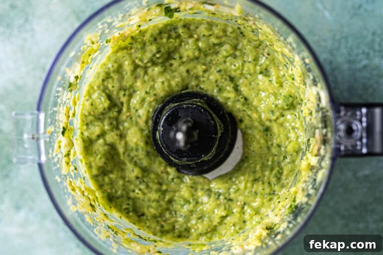 Blended avocado salsa in food processor.