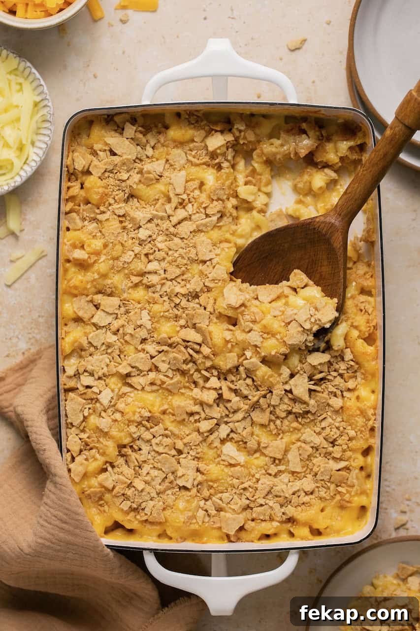 Creamy Oven-Baked Gluten-Free Mac and Cheese Recipe 7 baked gluten free mac and cheese with a serving spoon taking out a scoop