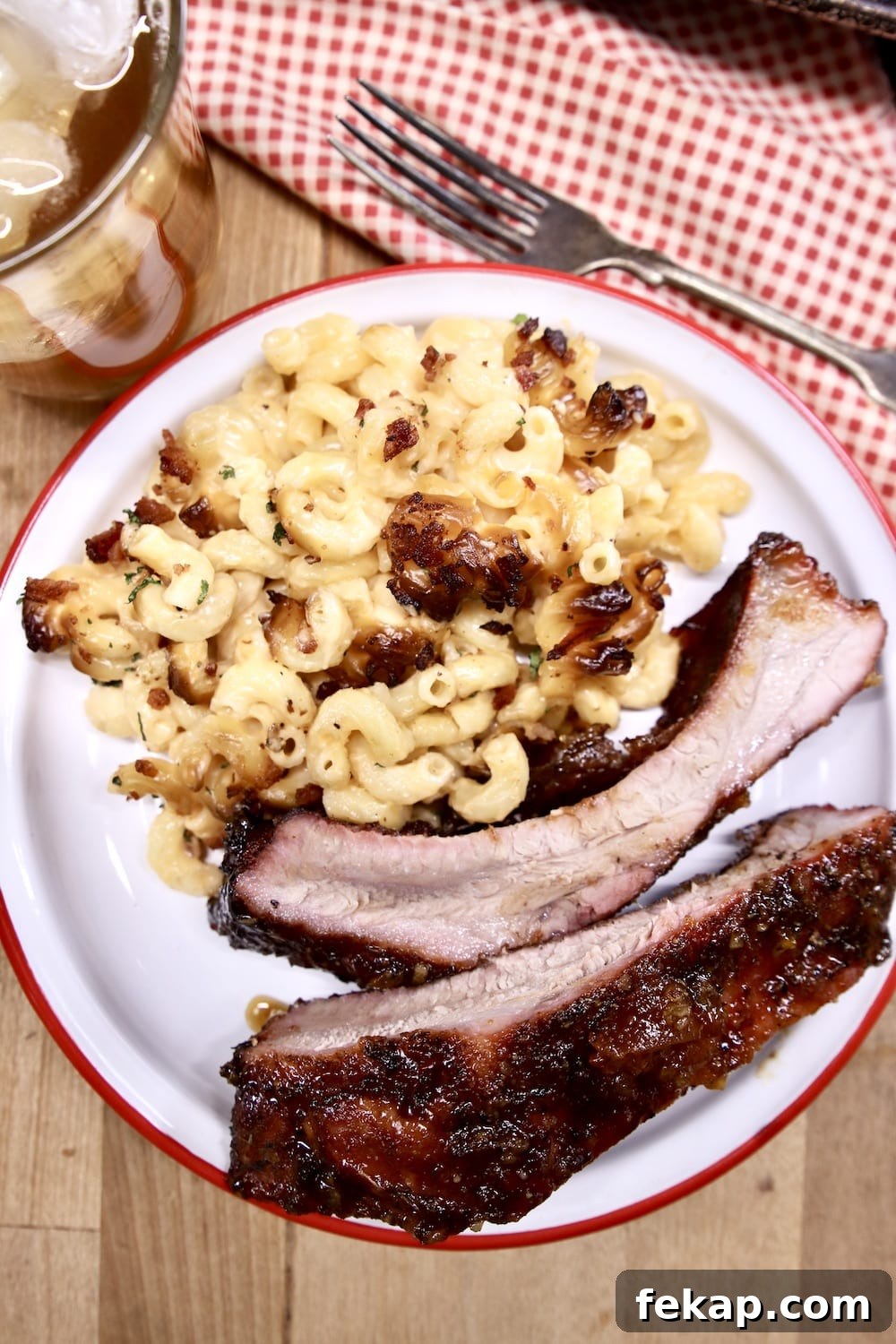 Apricot BBQ ribs served with mac and cheese Plate of mac and cheese with 2 baby back ribs