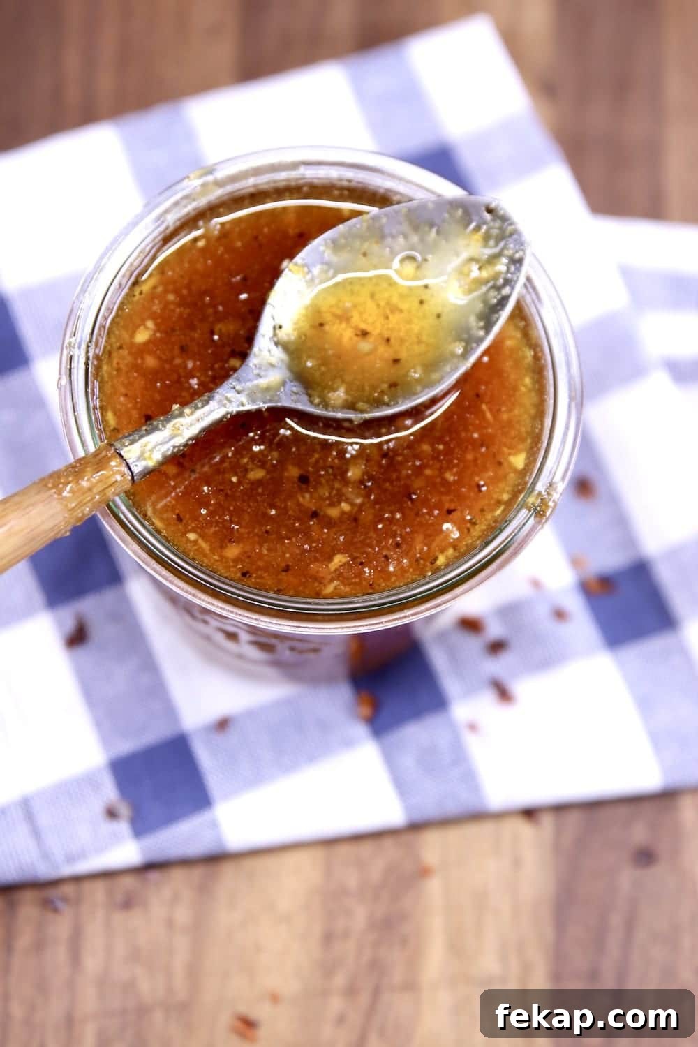 Apricot BBQ sauce for baby back ribs Jar of apricot bbq sauce with spoon resting on top
