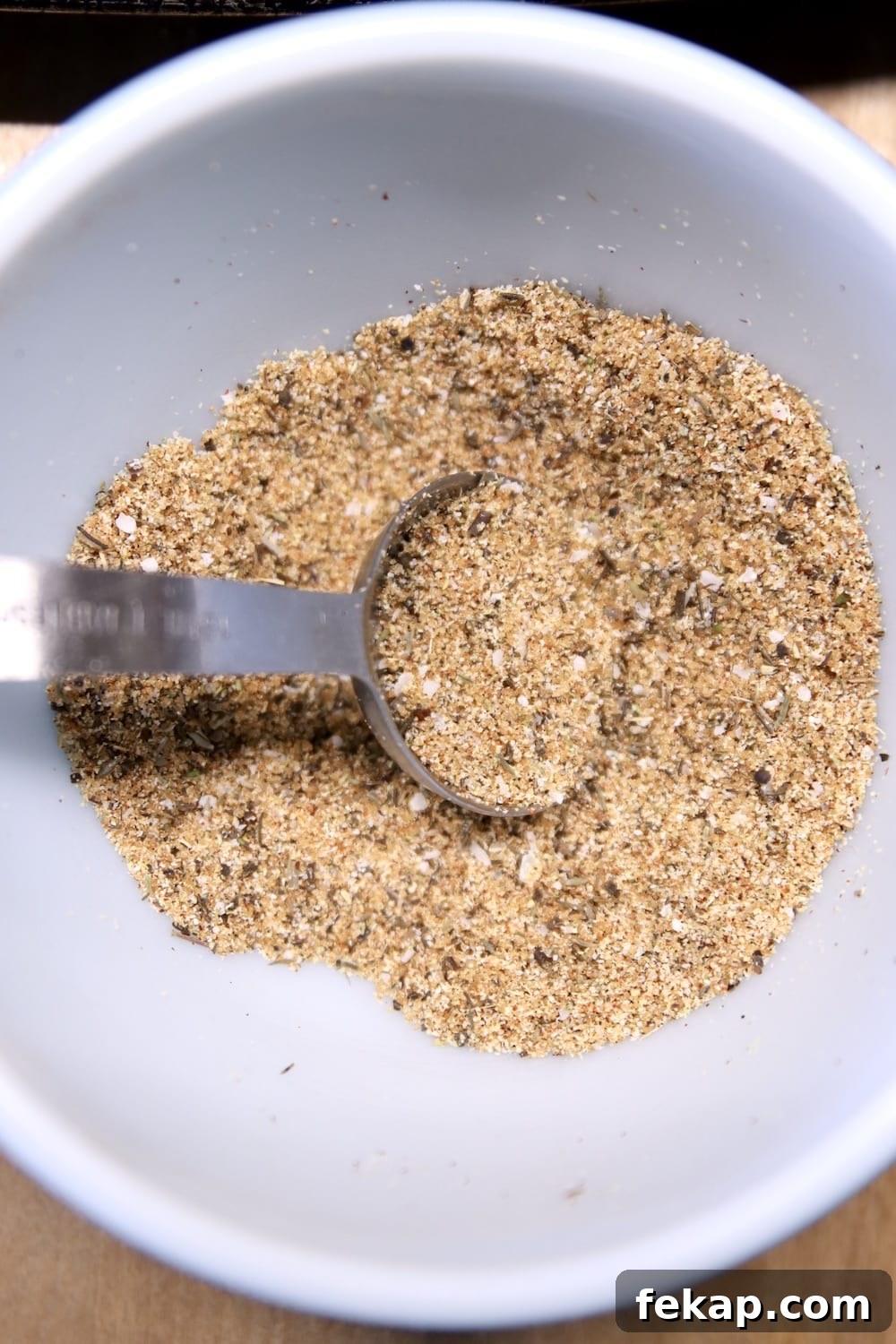 Dry rub for Apricot BBQ Ribs garlic and onion dry rub for ribs in a bowl with spoon