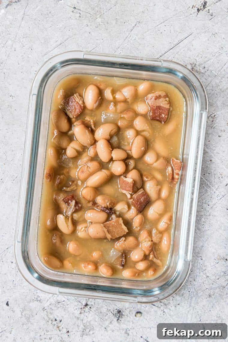 glass meal prep container filled with cooked pinto beans