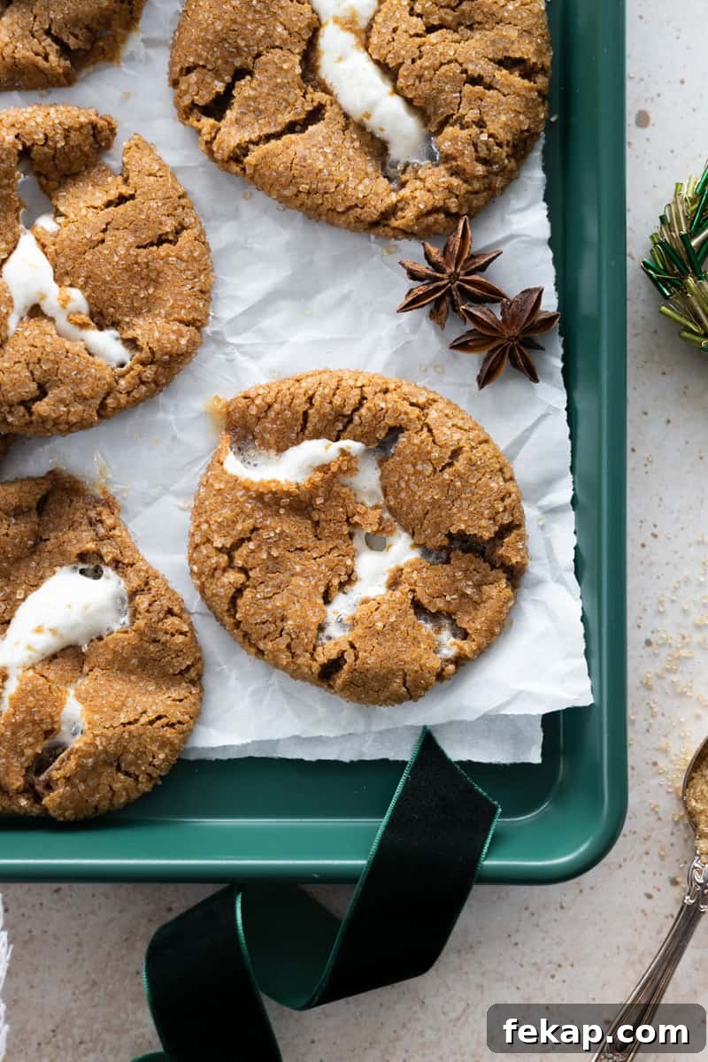 Molasses Marshmallow Stuffed Cookies on a green tray with white parchment paper.