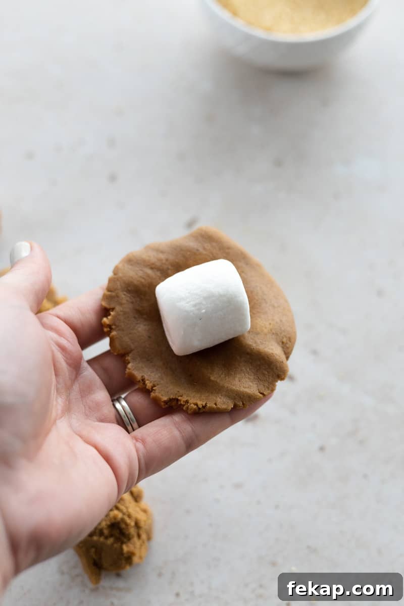 A marshmallow placed in the center of the dough.