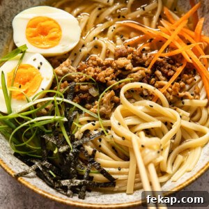 Japanese Udon Noodle Soup with Savory Broth 7 udon noodle soup topped with ground pork, boiled egg, green onion and carrots