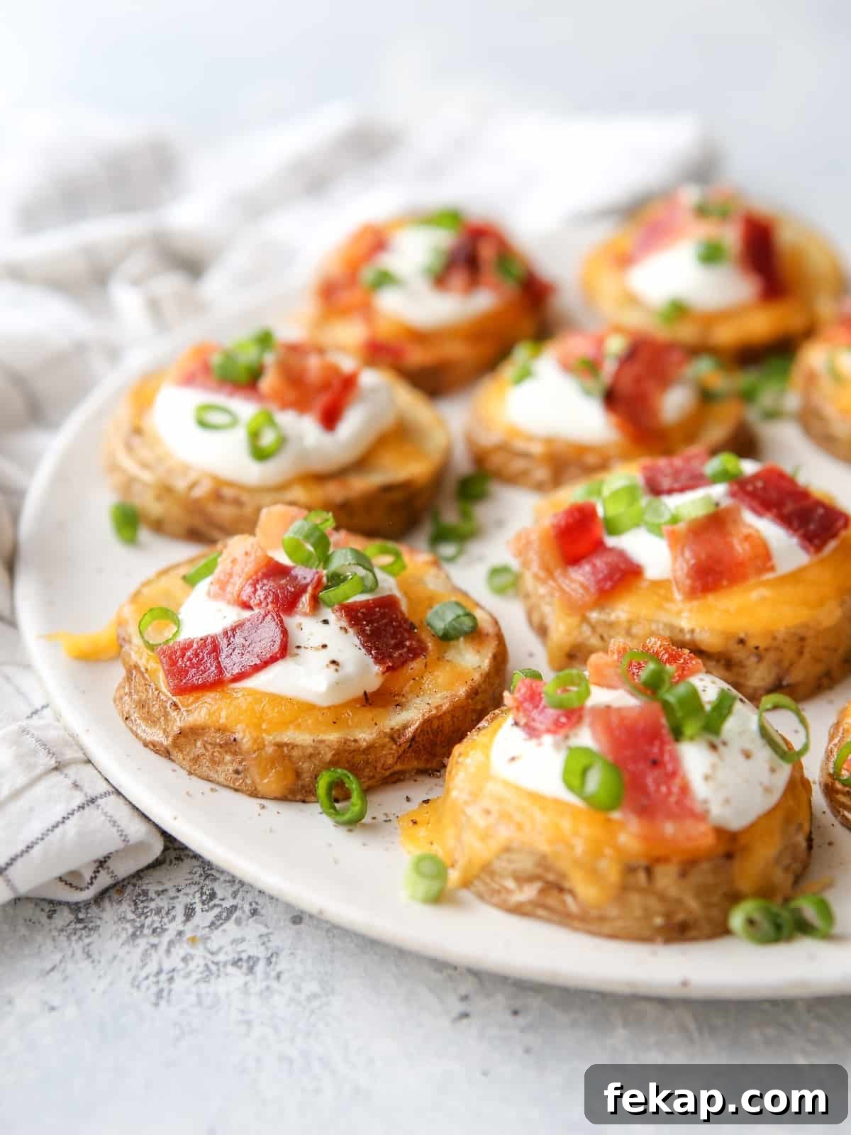 These irresistible baked potato bites are loaded up with cheese, sour cream, bacon and chives