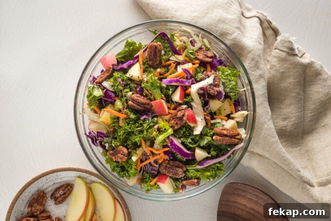 Crunchy Apple Cabbage Slaw with Brown Sugar Cider Vinaigrette 6 Apple cabbage slaw with shredded carrots and a brown sugar cider vinaigrette, served in a clear glass bowl.