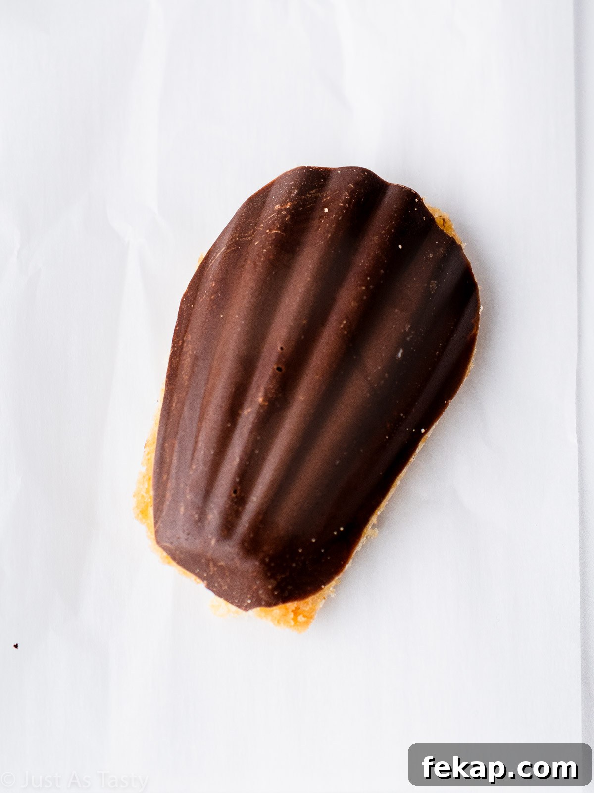 Gluten-Free Chocolate-Dipped Madeleines 3 Close-up of a chocolate dipped madeleine cookie.