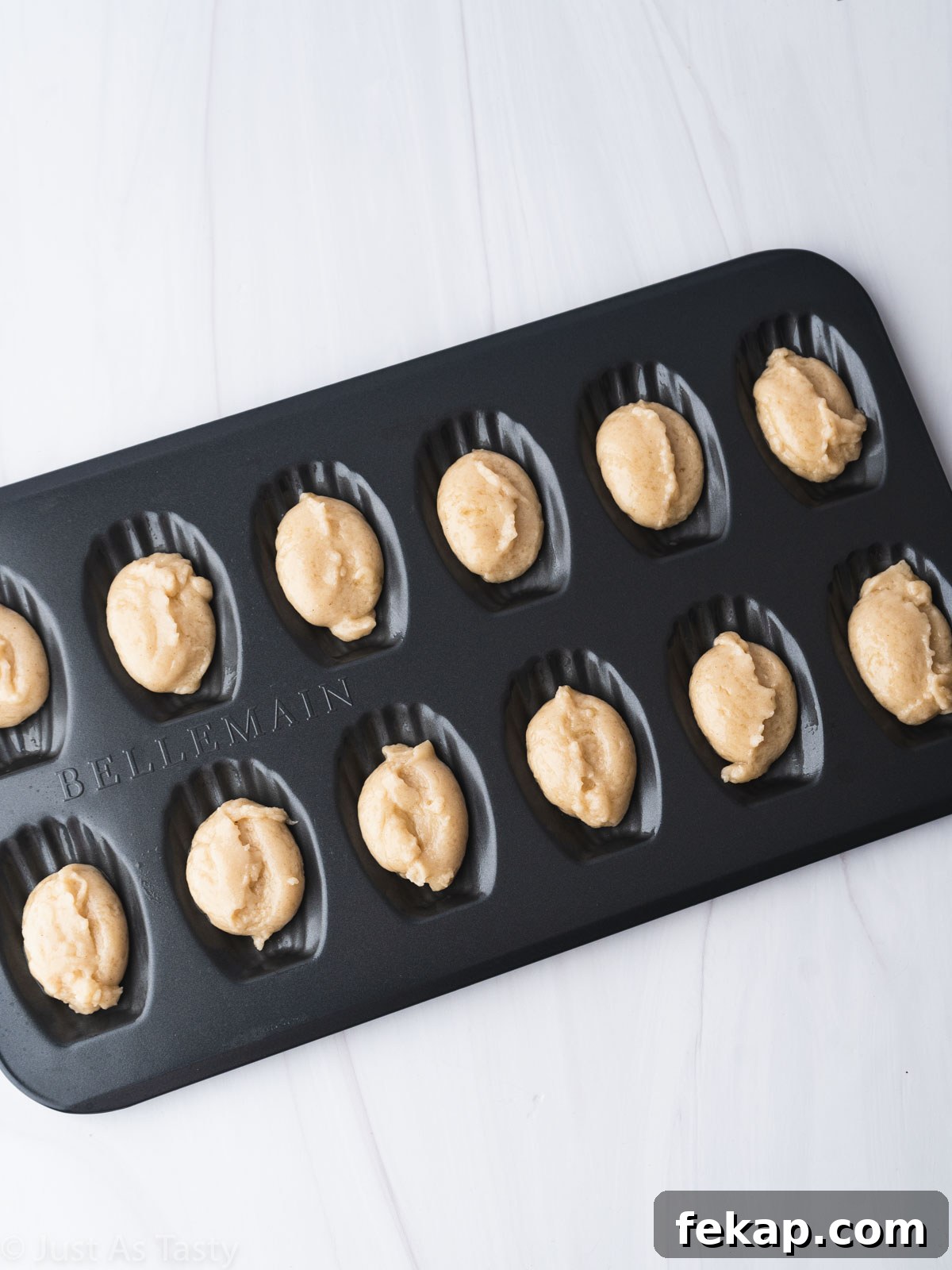 Gluten-Free Chocolate-Dipped Madeleines 8 Dough in a madeleine pan.