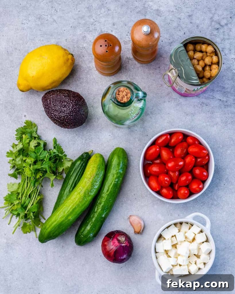 Chickpea and Feta Salad with Lemon Vinaigrette 4 Salad ingredients on a grey table.