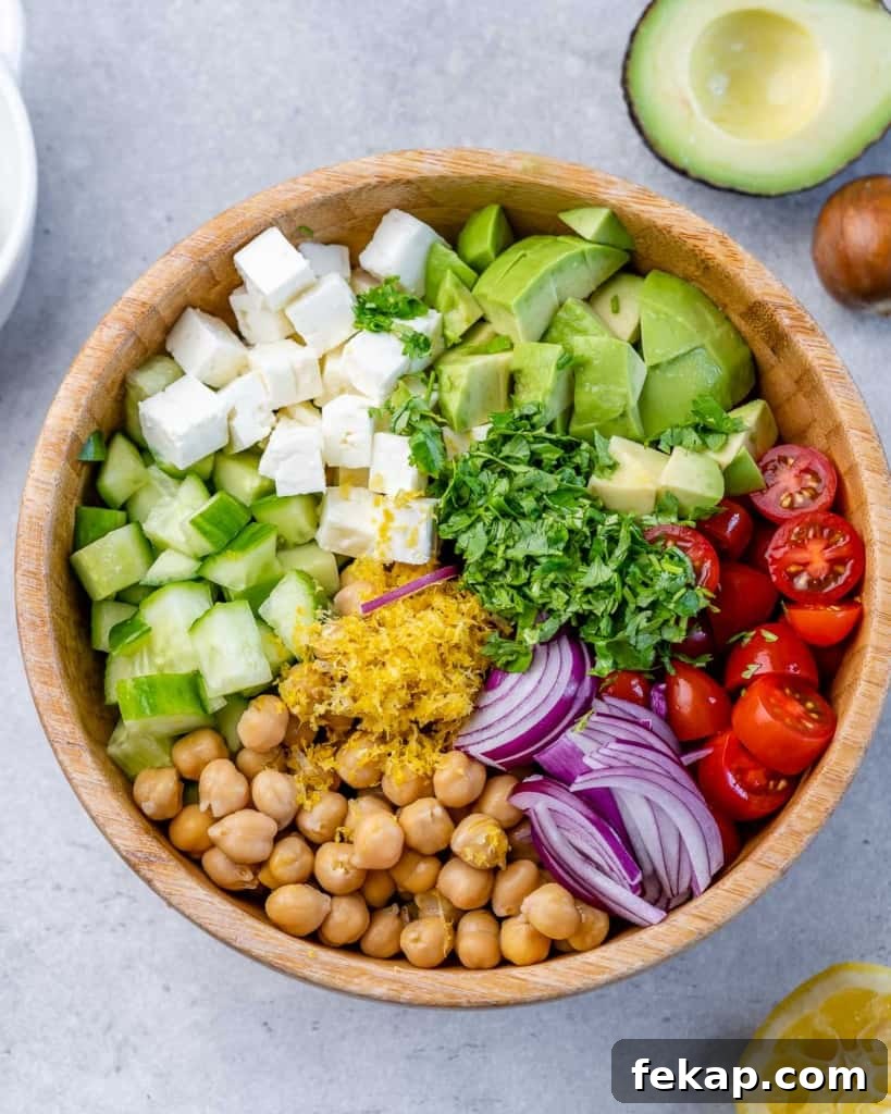 Chickpea and Feta Salad with Lemon Vinaigrette 5 Chickpea Feta Salad ingredients individually placed in a wooden bowl (not mixed).