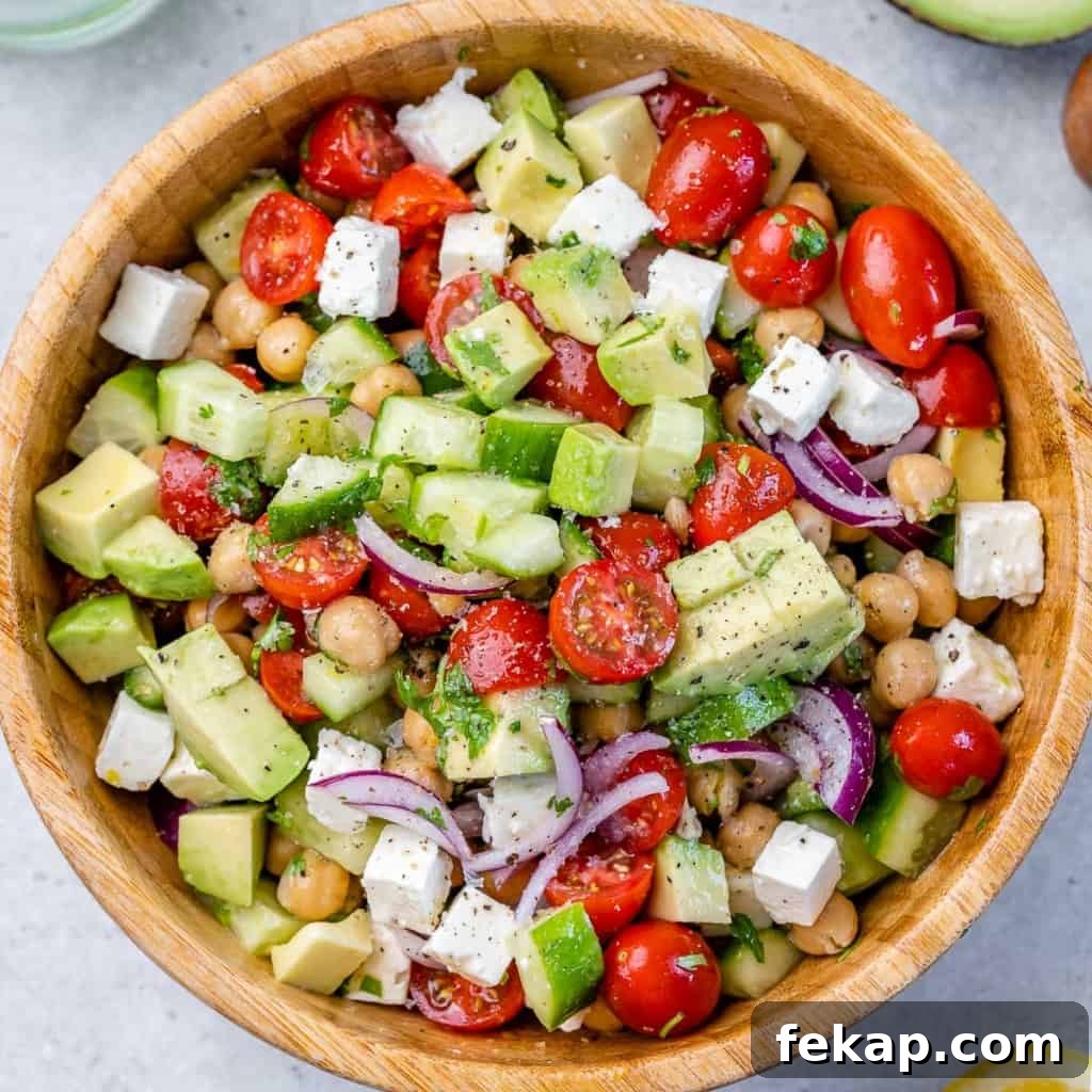 Chickpea and Feta Salad with Lemon Vinaigrette 7 top view chickpea tomato salad in a wooden bowl