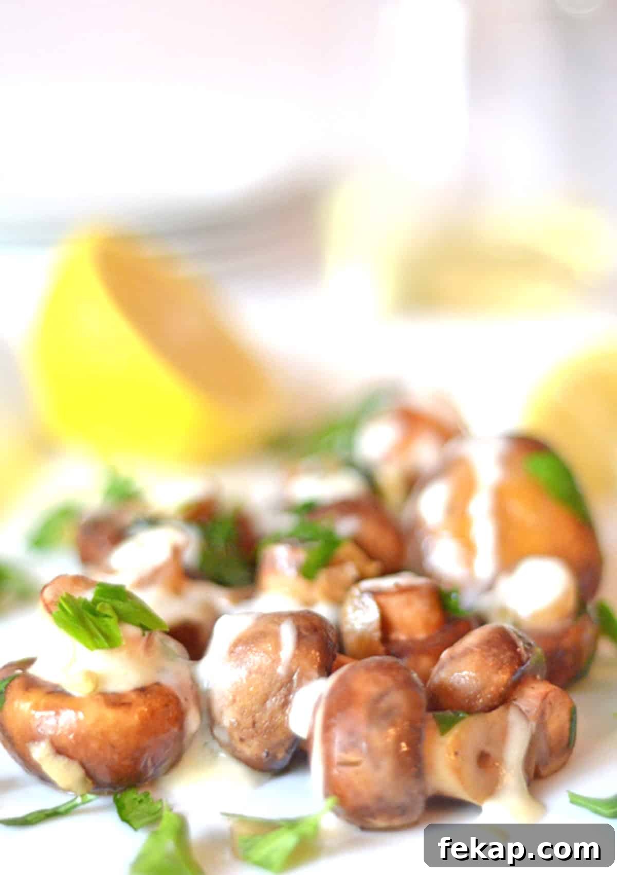 A plate of button mushrooms covered in cream.