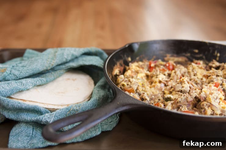 machaca breakfast Machaca con huevo recipe in a cast iron skillet with shredded beef, eggs, tomatoes, and onions, by Yvette Marquez-Sharpnack of Muy Bueno Mexican recipes.