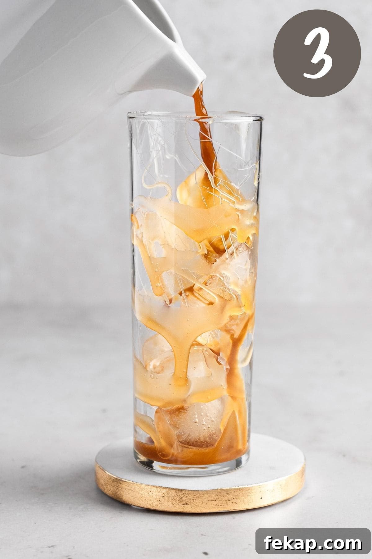 How to Make Caramel Iced Coffee at Home 5 Process photo illustrating the caramel coffee being poured into a glass with ice.