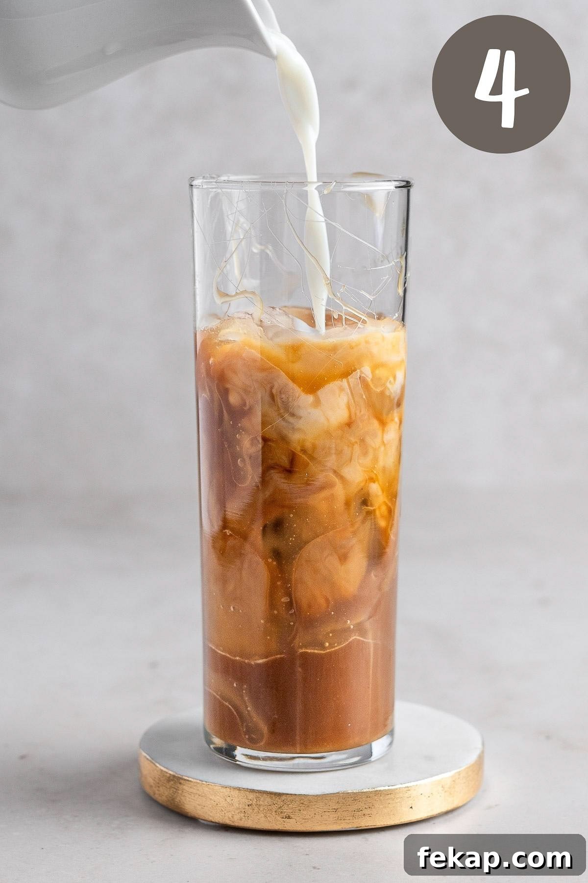 How to Make Caramel Iced Coffee at Home 6 Process photo illustrating the milk being poured into the caramel coffee.