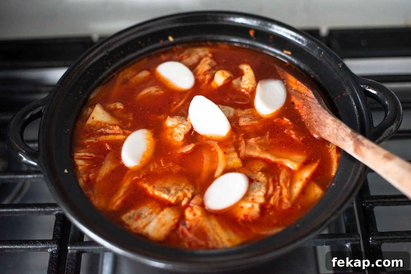 Thin rice cake rounds added to kimchi jjigae for extra texture and heartiness.