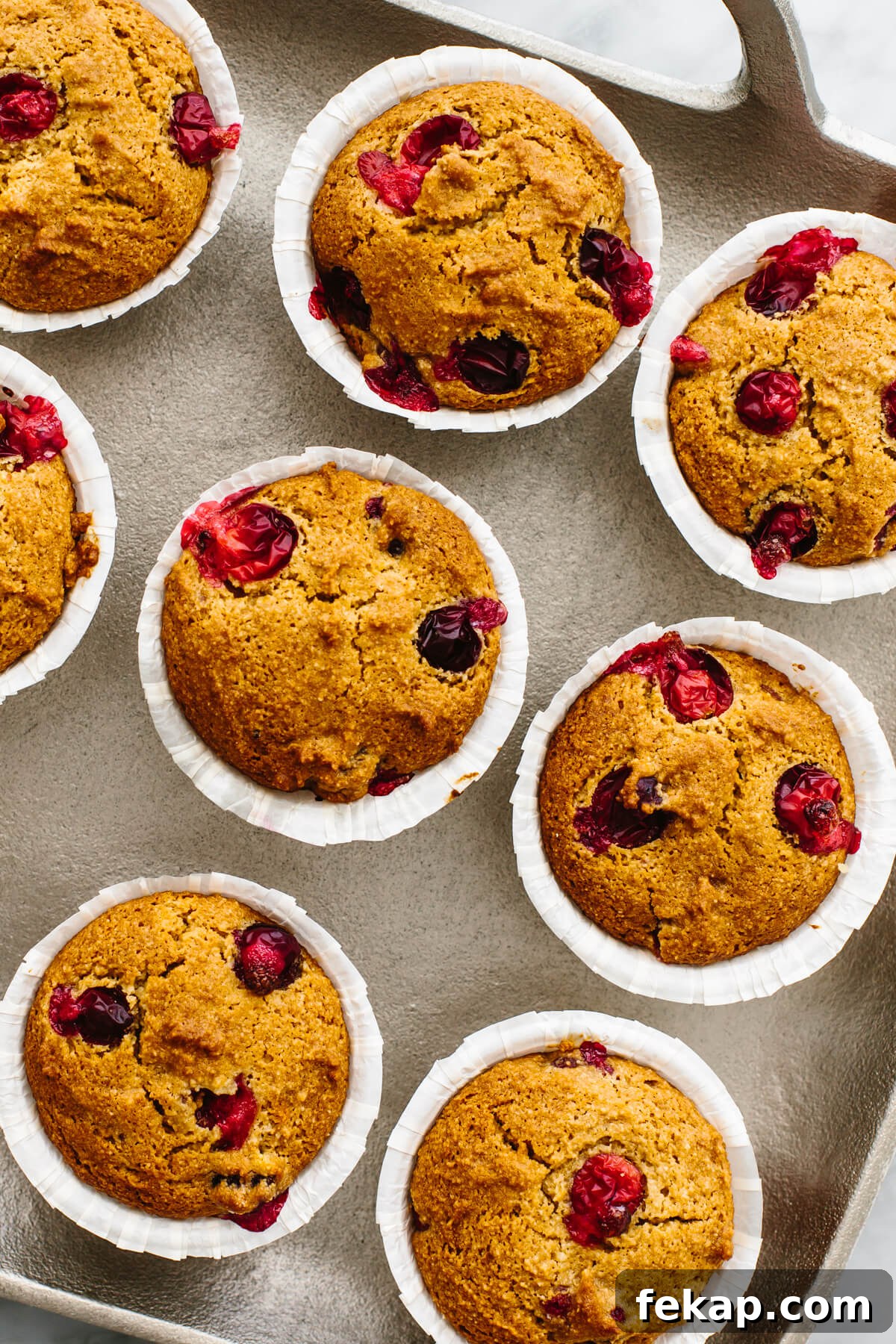A tray filled with cranberry orange muffins