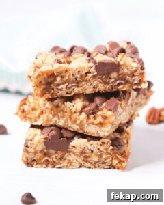 A stack of caramel chocolate oat bars with chocolate chips.