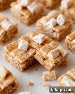 Homemade cinnamon toast crunch bars with marshmallows on a plate.