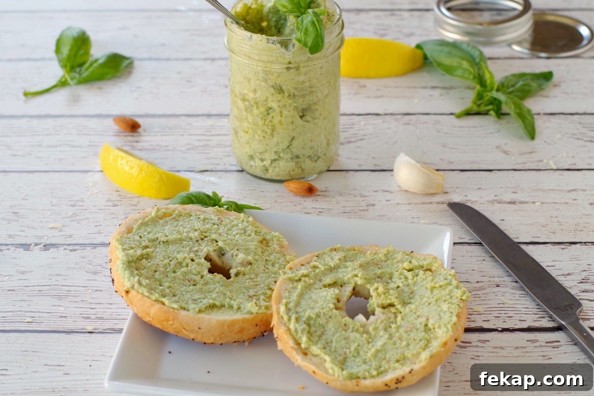 Almond Basil Pesto Recipe 9 basil almond pesto on bagel with a jar of pesto in the background