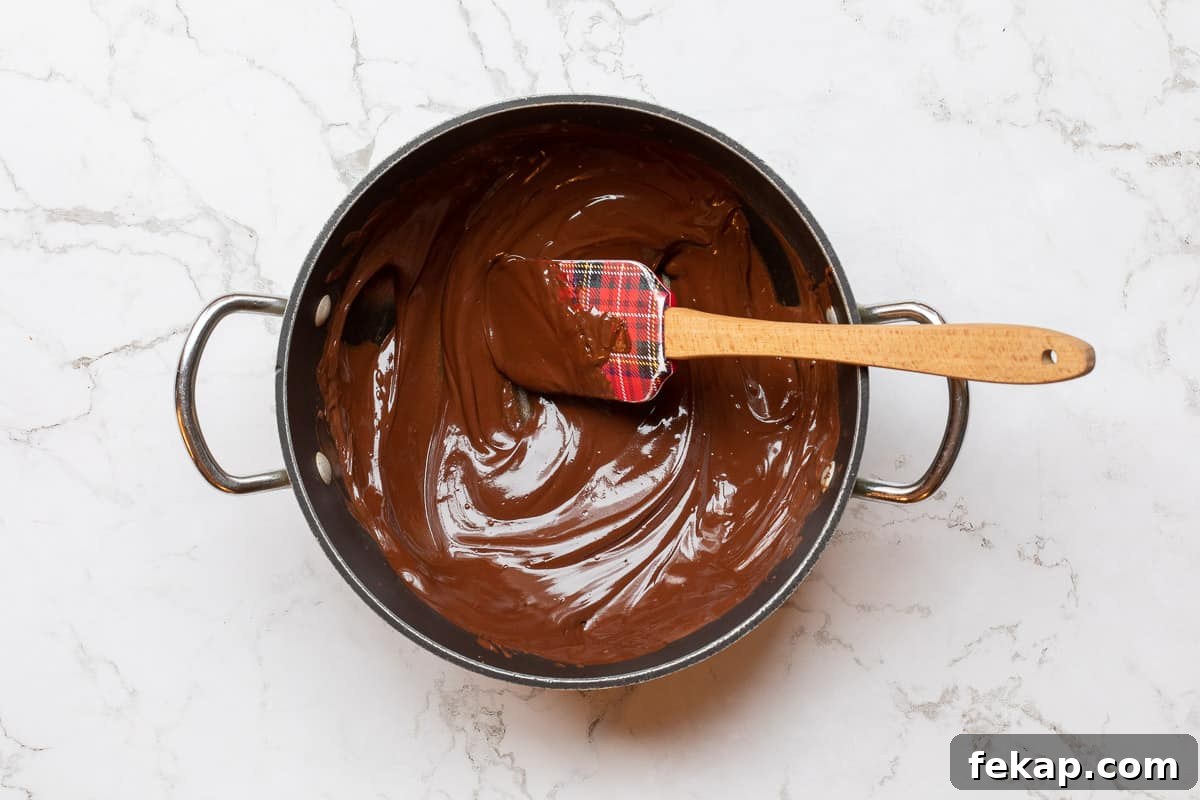 Double Chocolate Almond Flour Cookies 5 melted chocolate and butter in saucepan with spatula.
