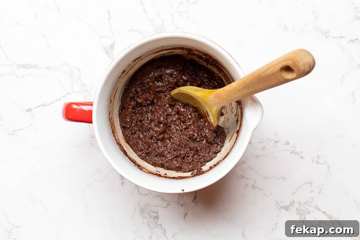 Double Chocolate Almond Flour Cookies 6 cookie batter for almond flour chocolate cookies in mixing bowl with spoon.