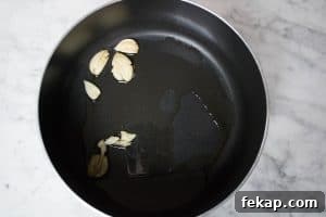 sautéing garlic to infuse the olive oil with flavor for the marinara sauce