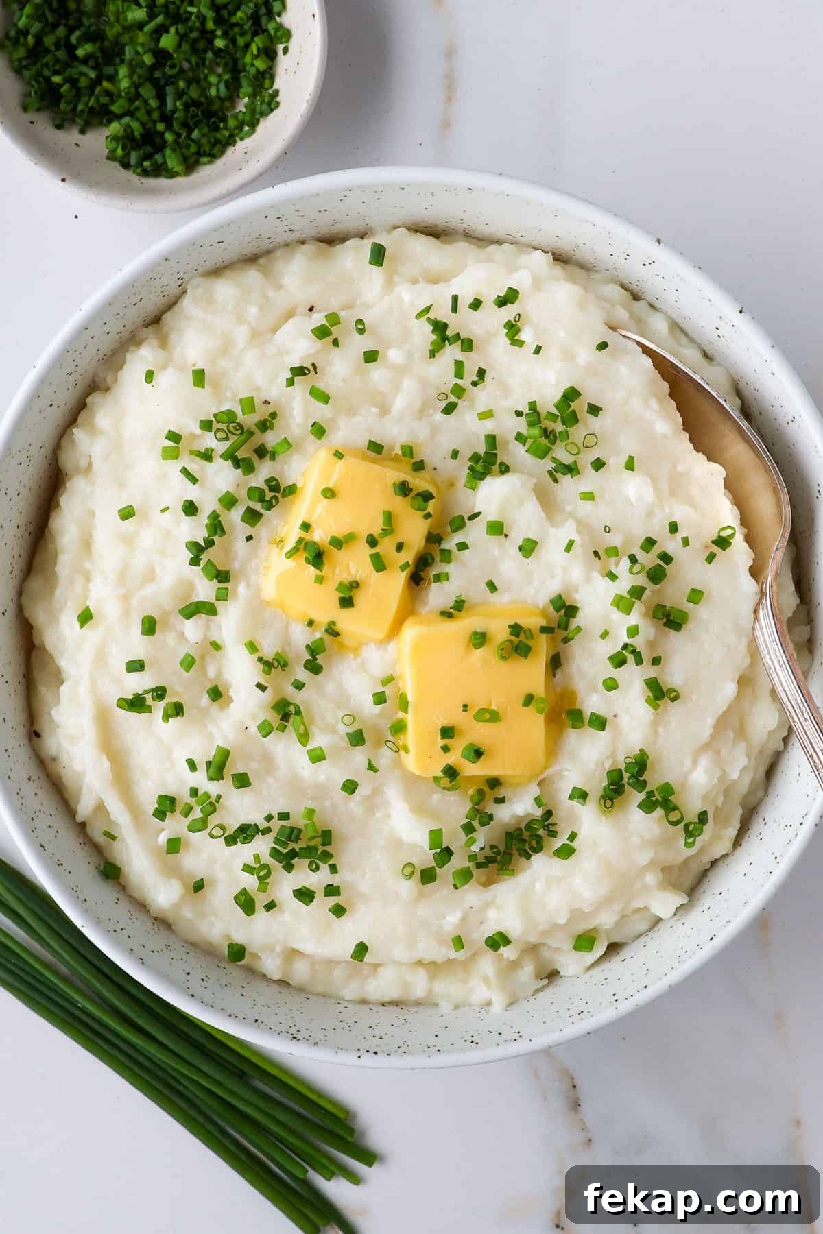 Creamy Cottage Cheese Mashed Potatoes Recipe 2 Mashed potatoes in a bowl with a spoon.