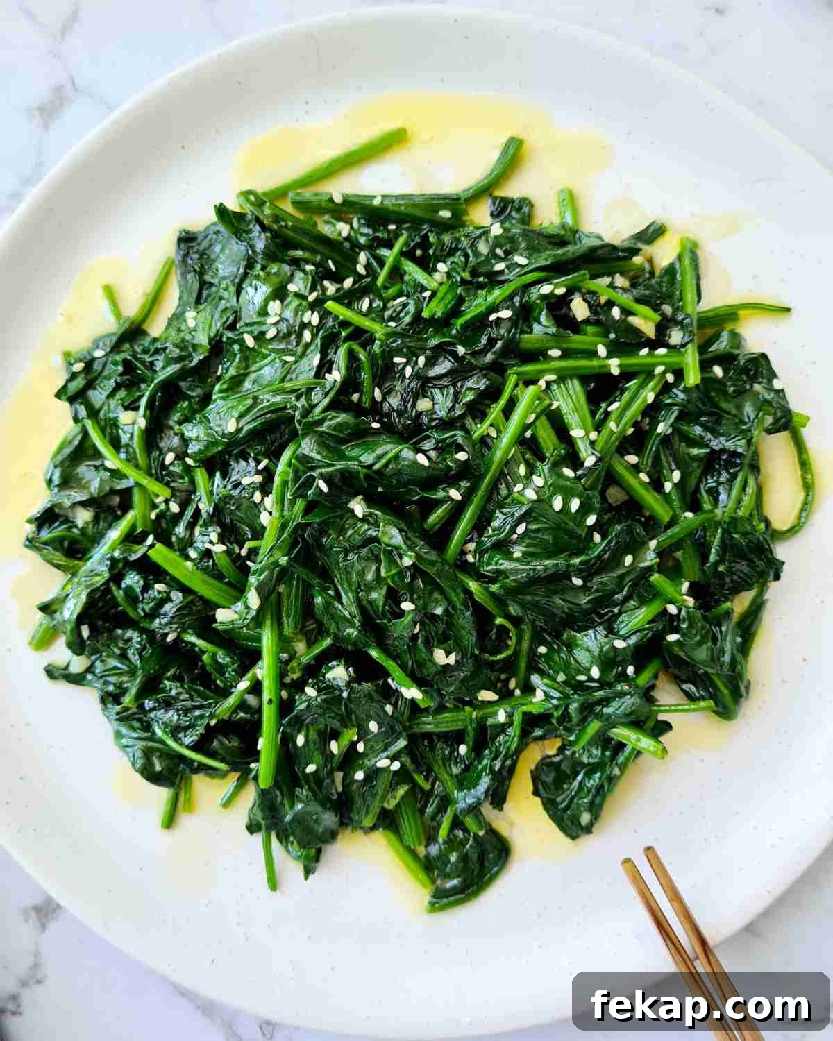 Garlic Stir-Fried Spinach Recipe 12 Sauteed spinach on a white plate