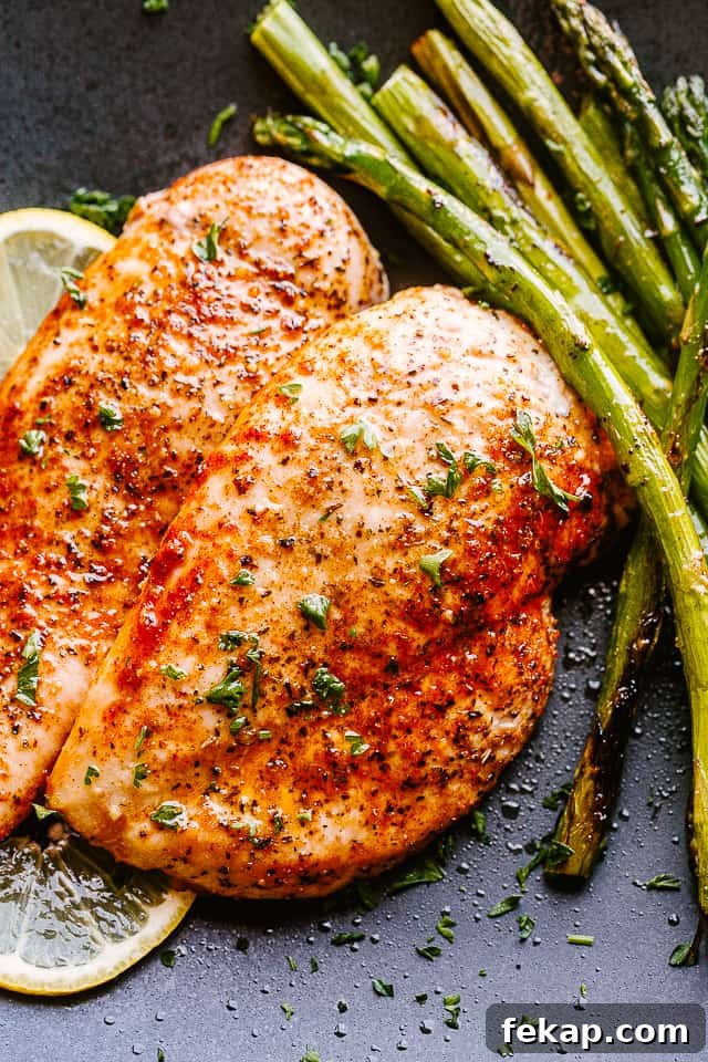 Air Fryer Chicken served on a black plate with asparagus.