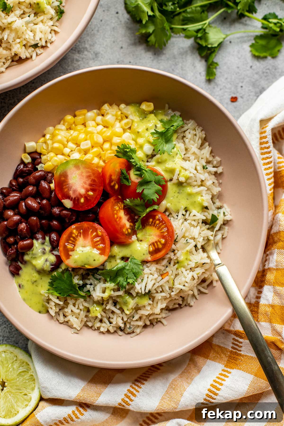 Cilantro lime rice in a bowl with black beans, corn, and tomatoes. 