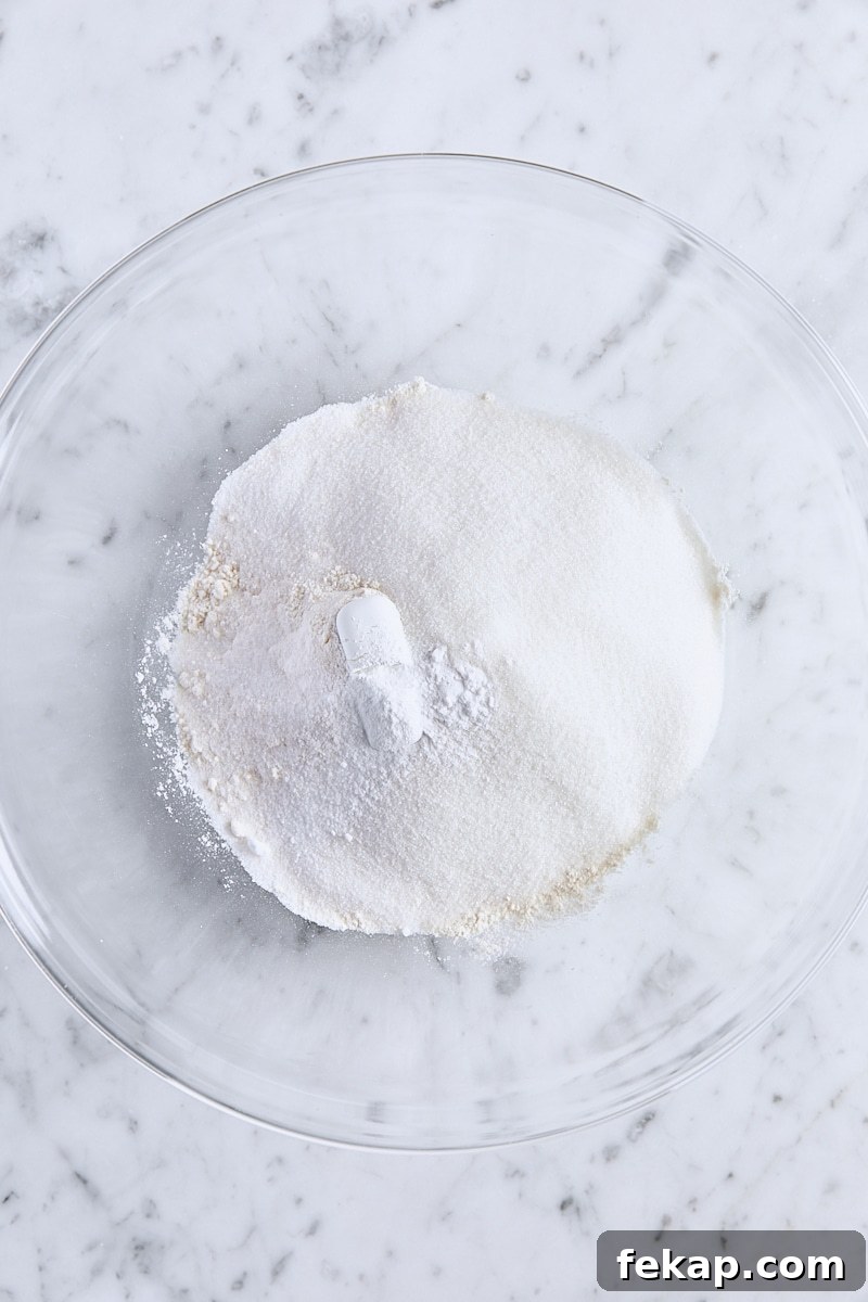 All-purpose flour, granulated sugar, baking powder, baking soda, and salt in large glass bowl