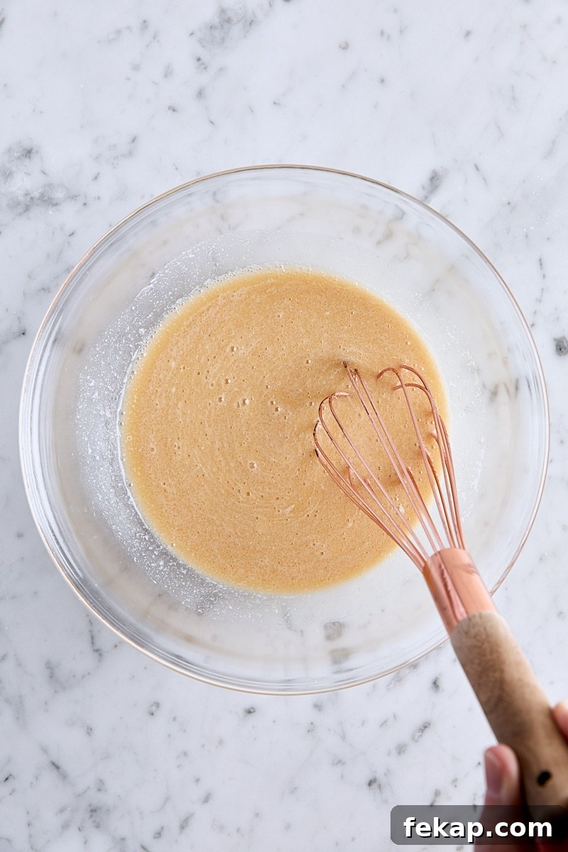 Wet ingredients whisked together in glass bowl