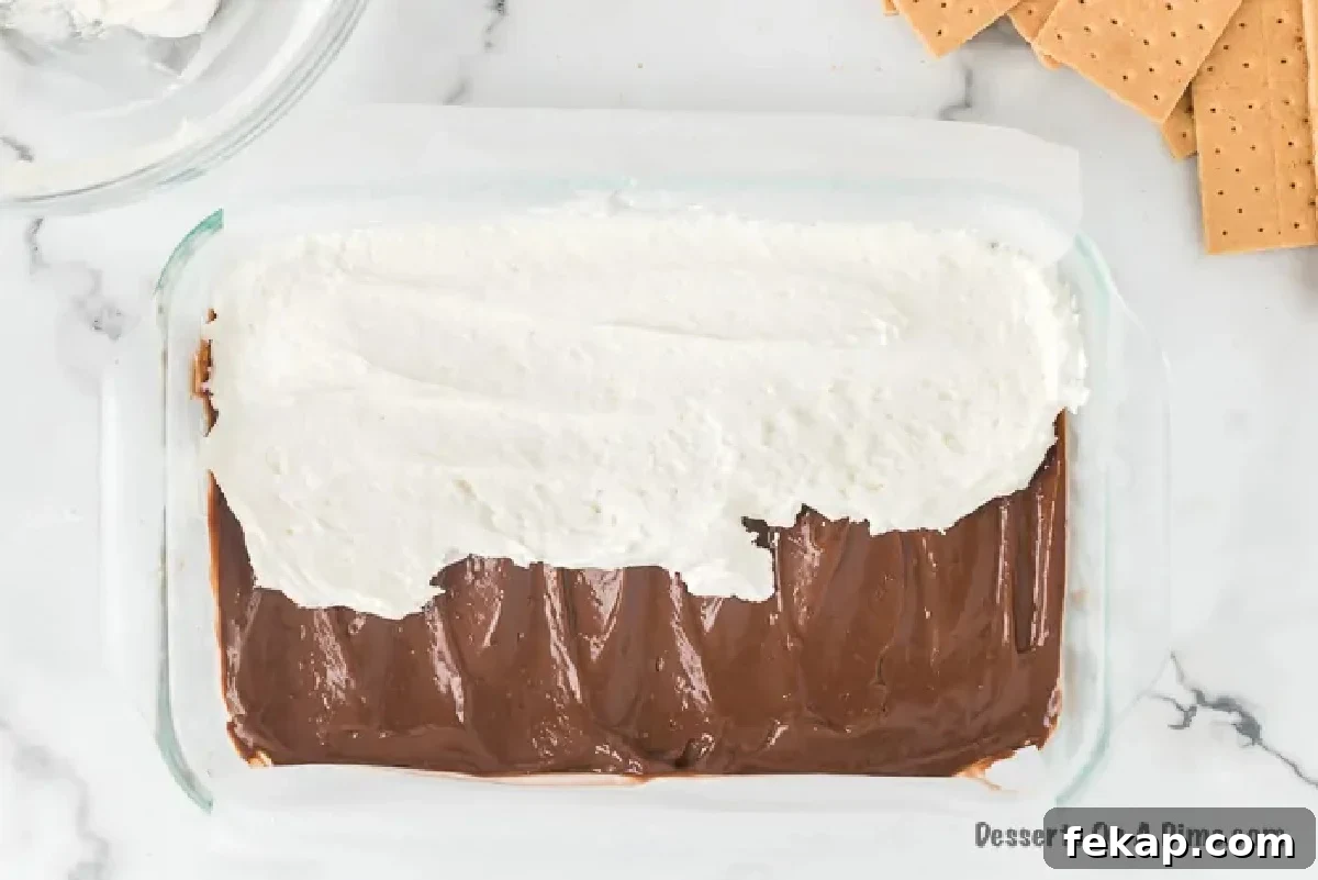 Marshmallow mixture spread over chocolate layer.