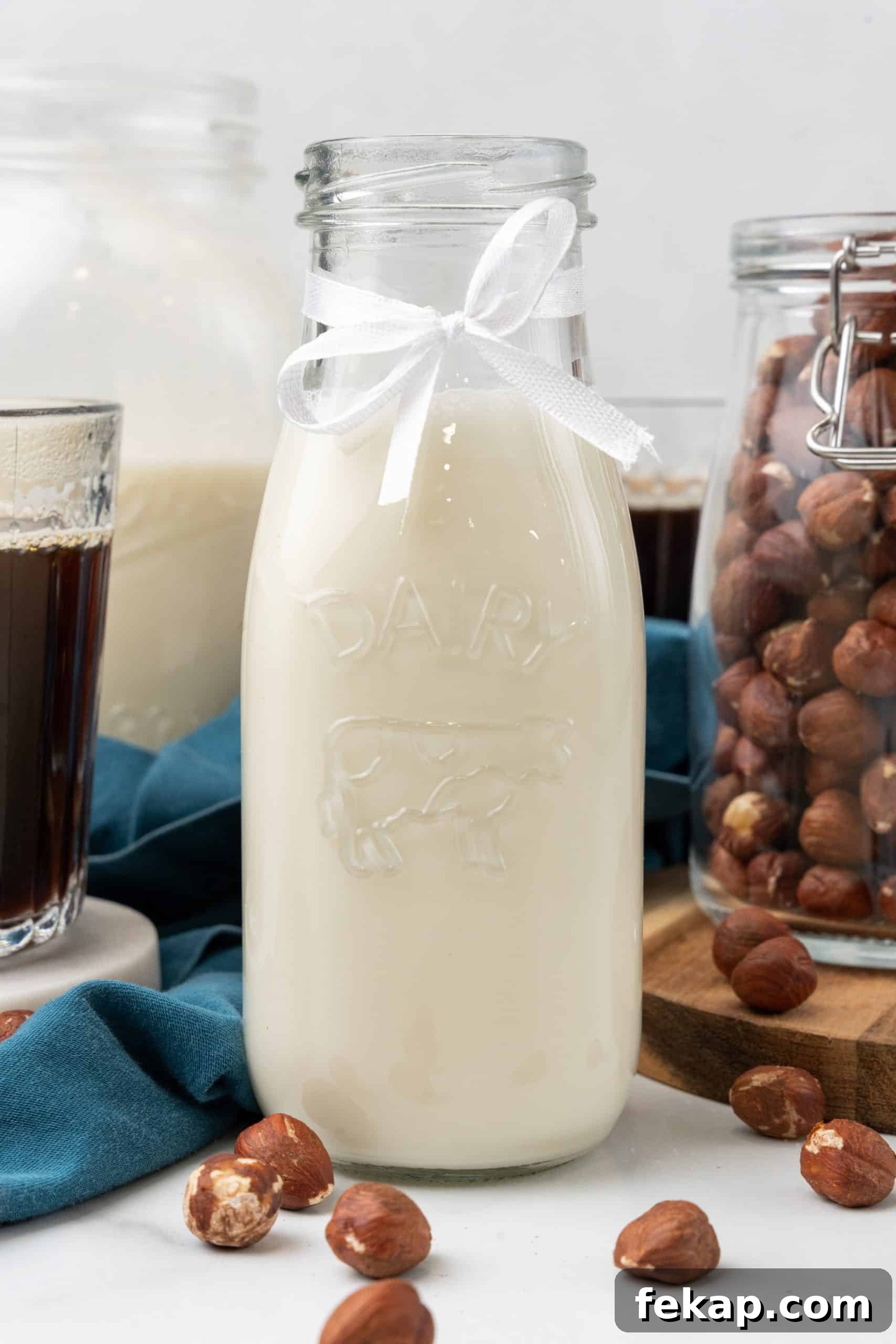 Make Your Own Hazelnut Coffee Creamer 2 homemade hazelnut coffee creamer in a glass jar on a marble coaster