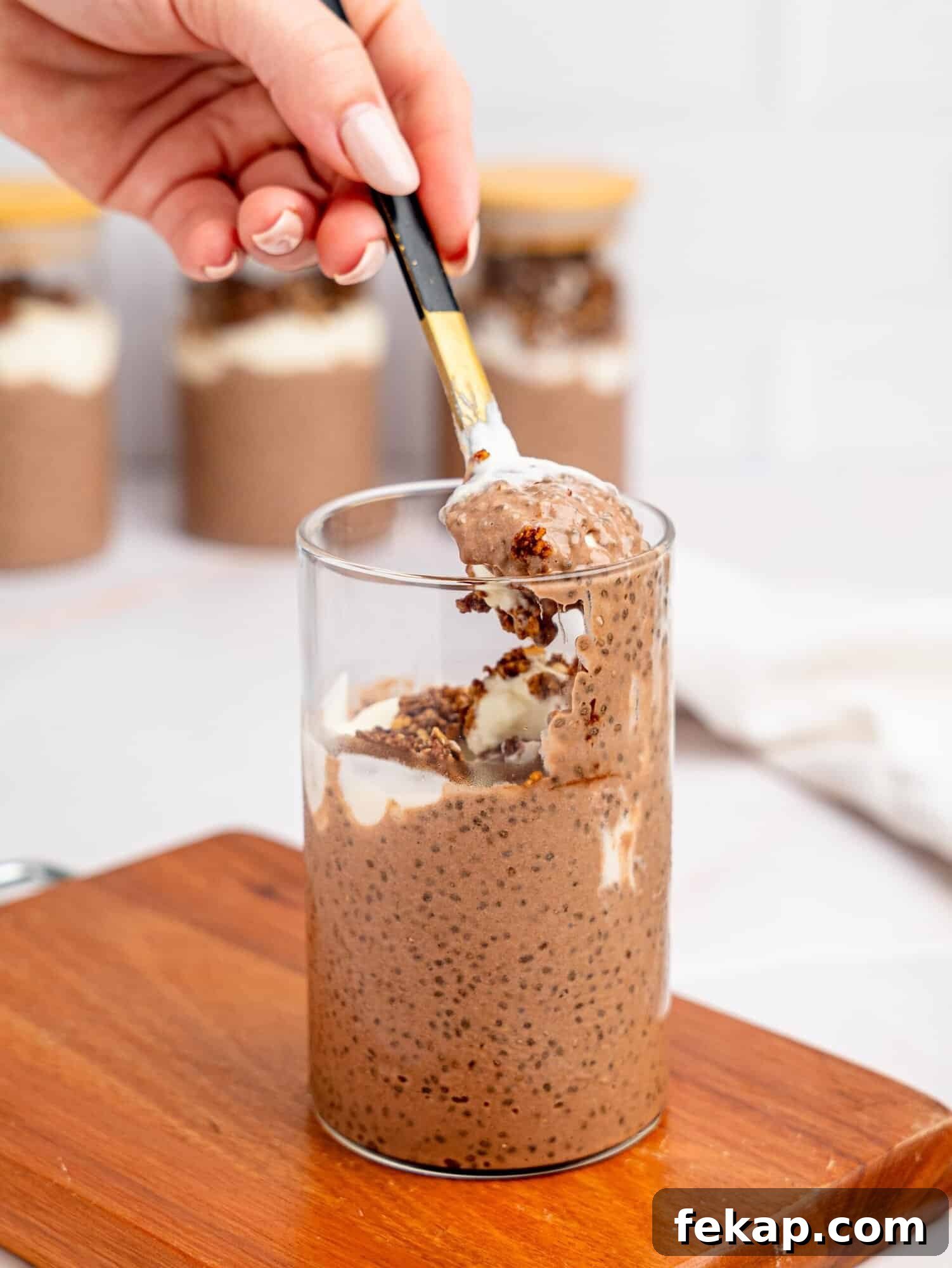 4-Ingredient High-Protein Chia Pudding 4 High protein chia pudding with yogurt and granola in a glass jar.
