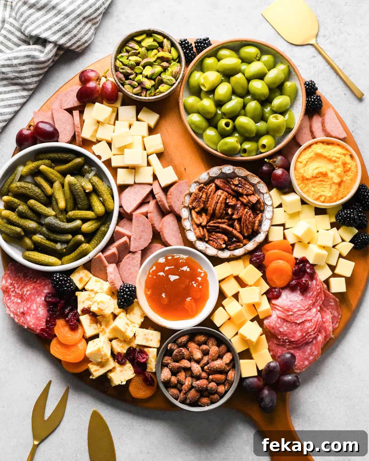 assembling a charcuterie board - fresh and dried fruit added 