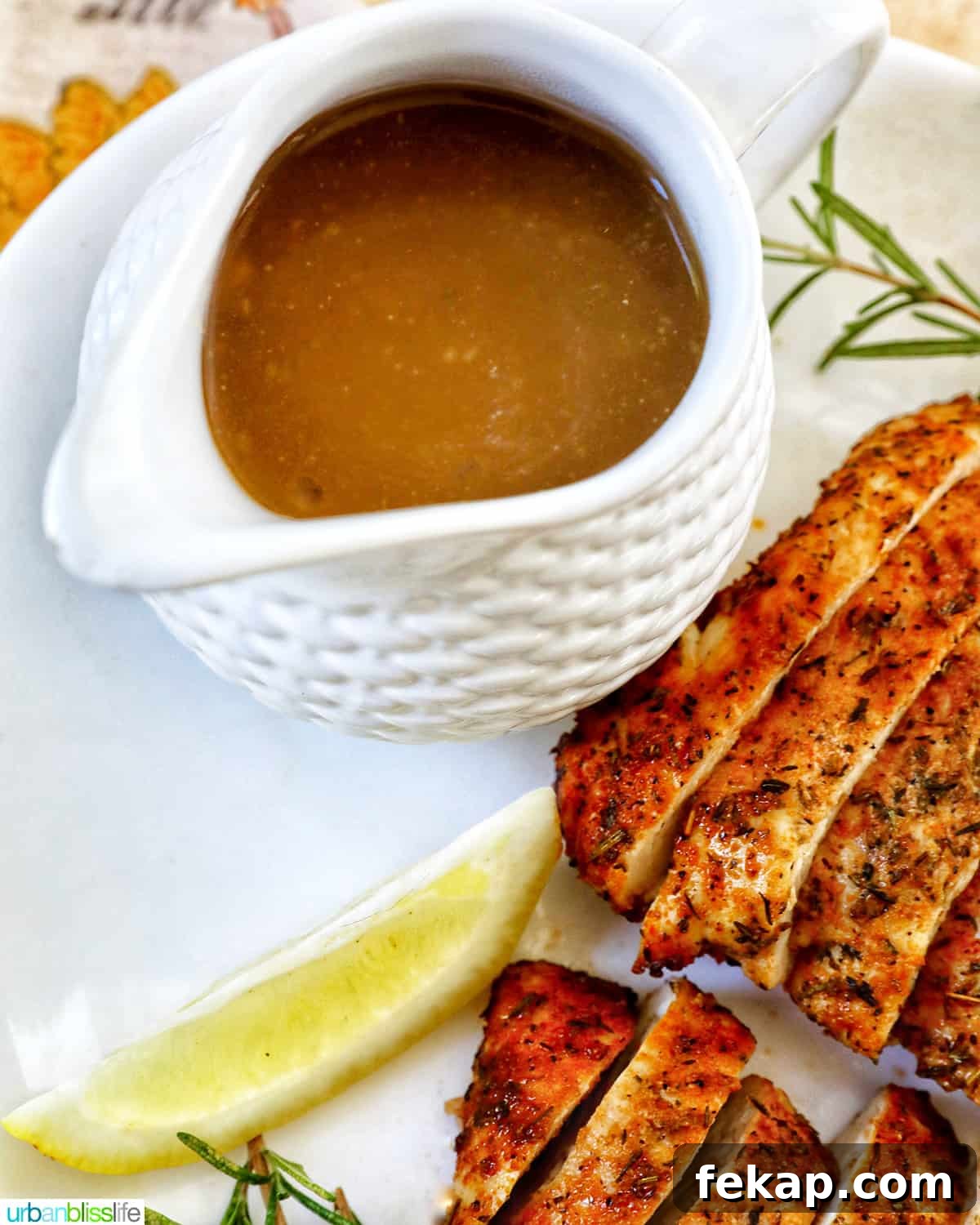 Air Fryer Turkey Tenderloin Recipe with Garlic Herb Rub 8 Turkey gravy in a gravy boat next to sliced turkey