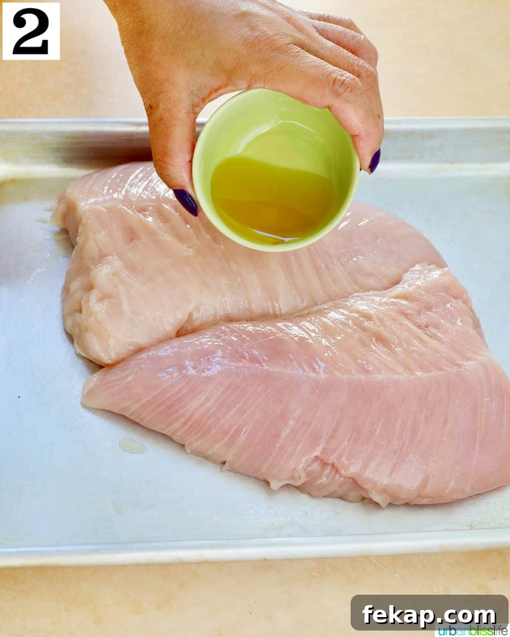 Air Fryer Turkey Tenderloin Recipe with Garlic Herb Rub 6 Pouring olive oil onto turkey tenderloins