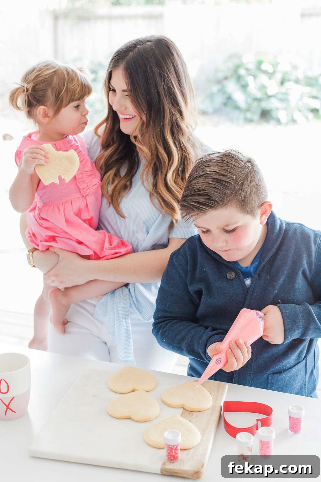 Cut Out Sugar Cookie Recipe for Perfect Shapes 2 Mom and children decorating cookies.
