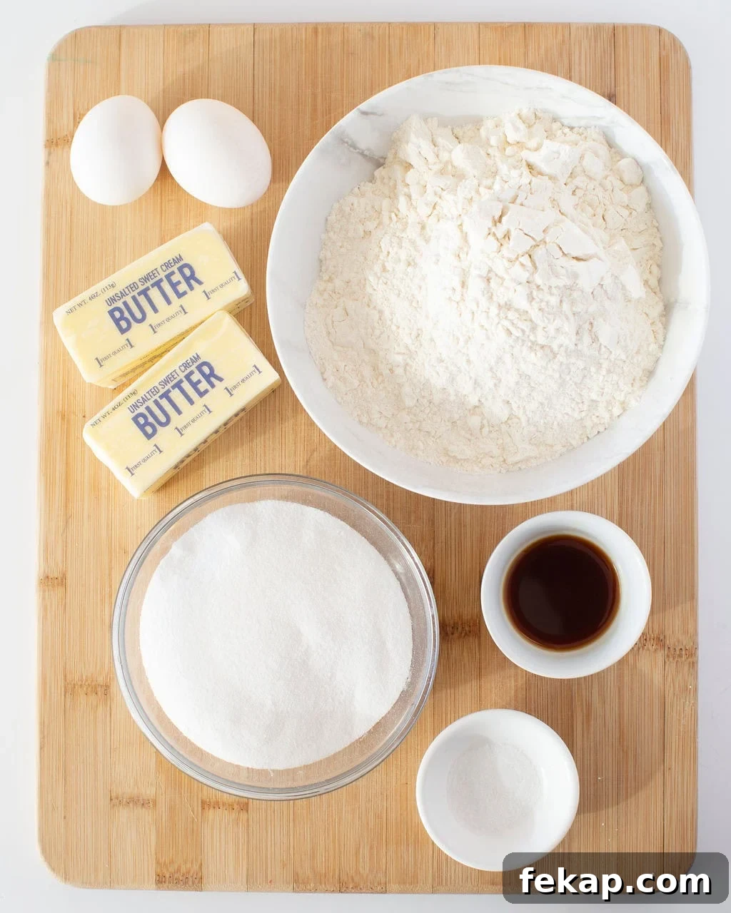 Cut Out Sugar Cookie Recipe for Perfect Shapes 3 Ingredients to make sugar cookies on a wooden cutting board.
