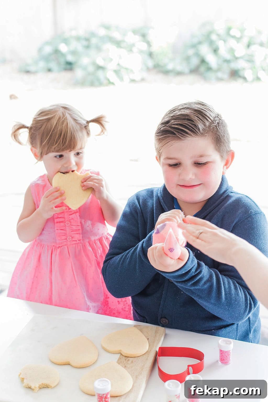Cut Out Sugar Cookie Recipe for Perfect Shapes 8 Two small children decorating cookies.