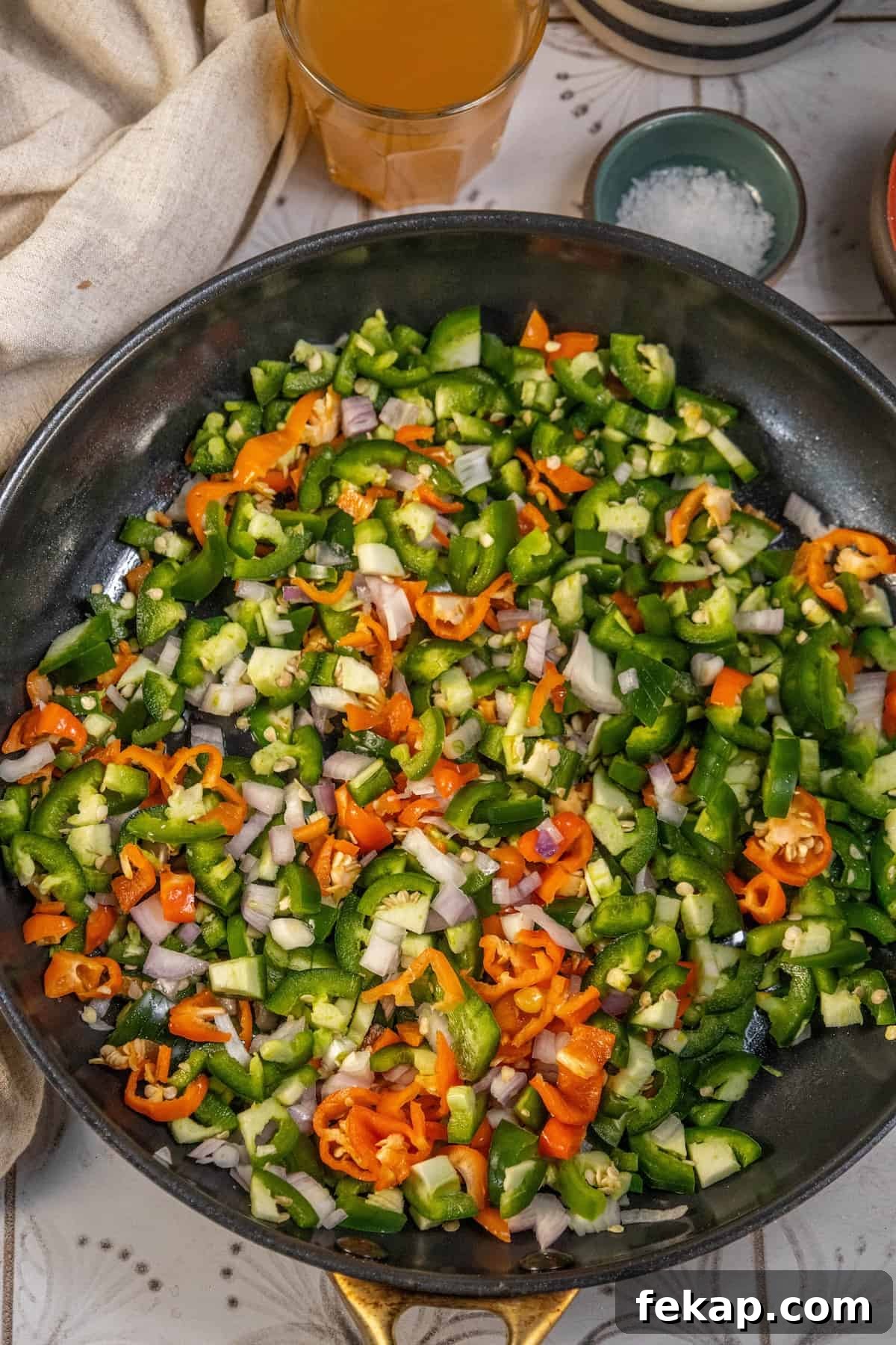 Homemade Habanero Hot Sauce Recipe: Fiery Flavor 5 A frying pan with vegetables in it, enhanced with a hint of hot sauce.