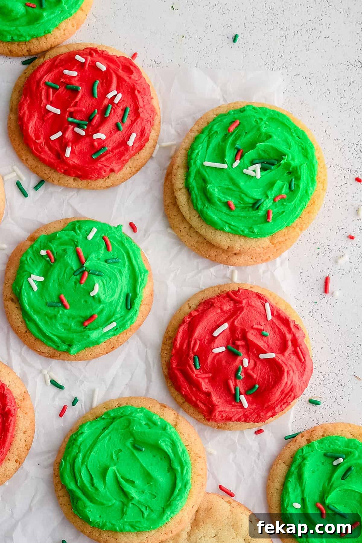 Soft and Chewy Sugar Cookies Recipe 4 sugar cookies on parchment paper with frosting